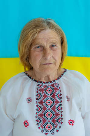 Grandmother is a Ukrainian patriot in an embroidered shirt. selective focus.の写真素材