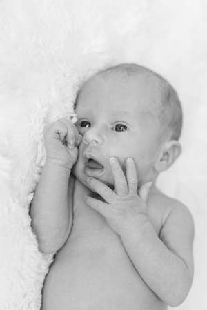 Newborn baby on a white background. Selective focus.