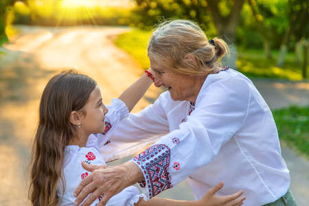 Ukrainian grandmother and granddaughter in vyshyvanka. selective focus.
