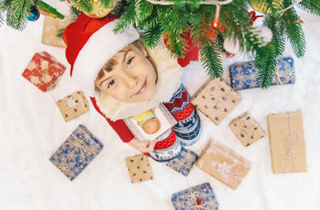 Child happy over christmas background. Christmas tree. Selective focus.
