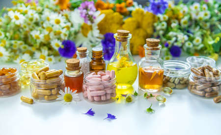 Tinctures, extracts, oils and dietary supplements from medicinal herbs. Selective focus.の写真素材