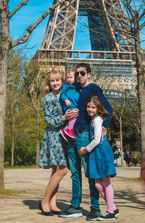 Family photo near the eiffel tower. Selective focus.の写真素材