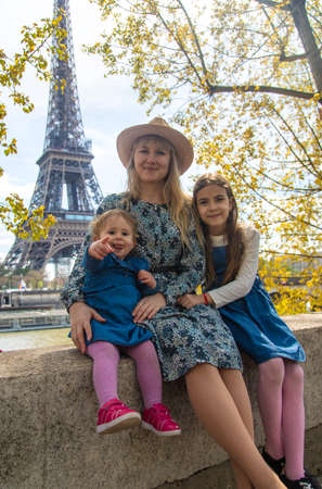 Woman with children near the eiffel tower. selective focus. kids.の写真素材