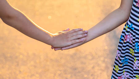 Children walk hand in hand. selective focus. kids,の写真素材