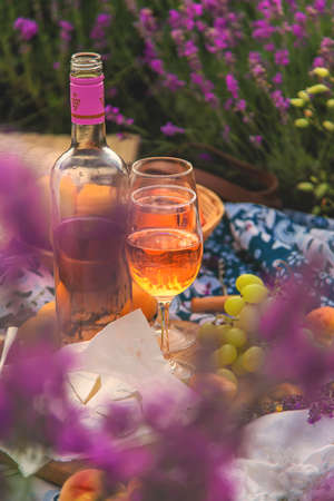 Wine in a lavender field. selective focus. food.の写真素材