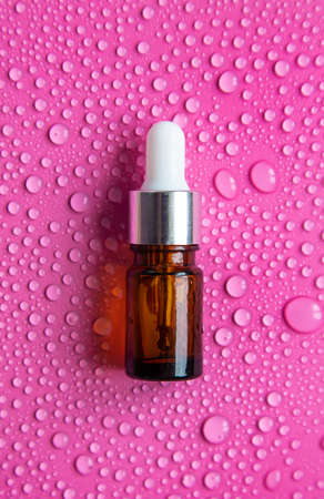 Bottle of cosmetics and drops of liquid, moisturizing. hyaluronic acid. selective focus. Spa.の写真素材