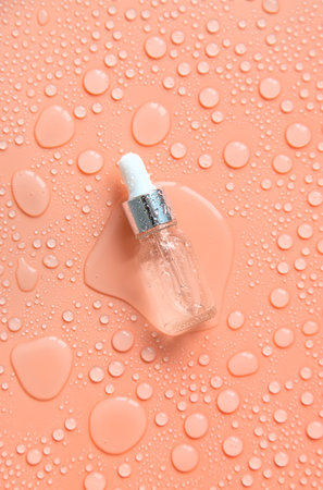 Bottle of cosmetics and drops of liquid, moisturizing. hyaluronic acid. selective focus. Spa.の写真素材