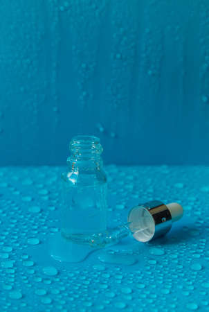 Bottle of cosmetics and drops of liquid, moisturizing. hyaluronic acid. selective focus. Spa.の写真素材