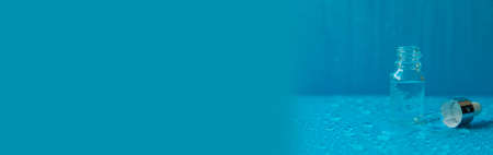 Bottle of cosmetics and drops of liquid, moisturizing. hyaluronic acid. selective focus. Spa.の写真素材