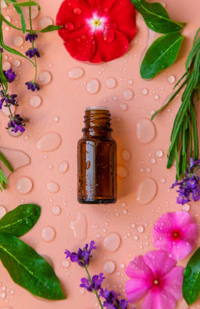 Background with water drops bottle with essential oil and flowers. selective focus. Spa.の写真素材