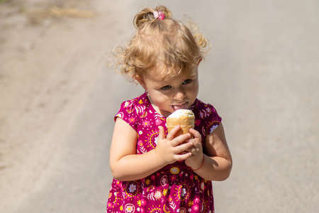 The child eats ice cream on the street. selective focus. food.の写真素材