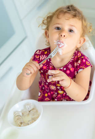 The child eats dumplings at the table. selective focus. kid.の写真素材