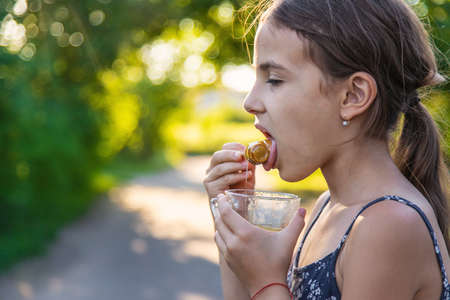 A child eats honey in the park. selective focus. kid.の写真素材