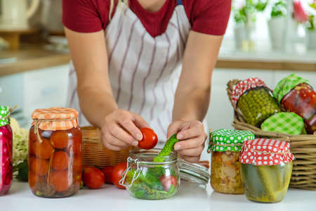 Woman jar preserve vegetables in the kitchen. selective focus. food.の写真素材