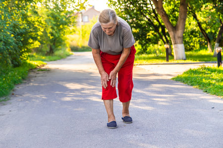grandmother hurts her knees on the road. selective focus. people.の写真素材