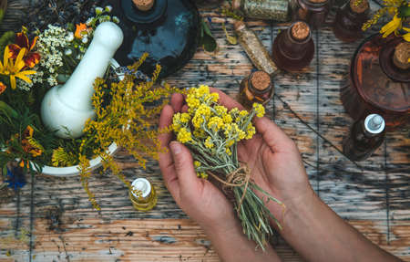 Woman with medicinal herbs and tinctures. selective focus. Nature.の写真素材