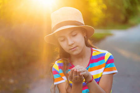 The child is playing with the frog. Selective focus.の写真素材