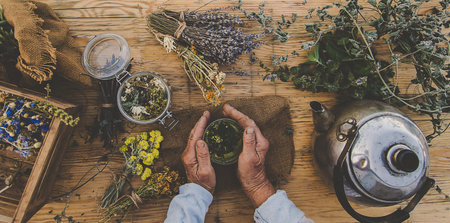 Grandmother makes tea with medicinal herbs. Selective focus.の写真素材