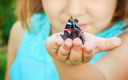 Child with a butterfly. Selective focus. nature.の写真素材