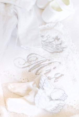 Clothes and a cross for the babys christening. Selective focus.の写真素材