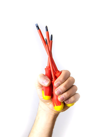 Electricians screwdriver in hand isolate. Selective focus.の写真素材