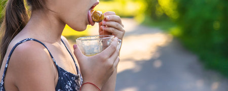 A child eats honey in the park. selective focus. kid.の写真素材