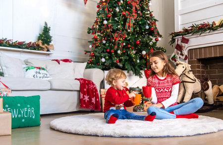 Children drink tea near the Christmas tree. selective focus. kid.の写真素材