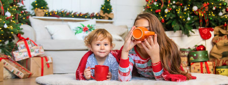 Children drink tea near the Christmas tree. selective focus. kid.の写真素材