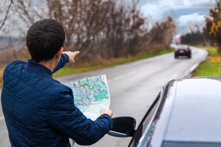A man looks at a map on the road. selective focus. people.