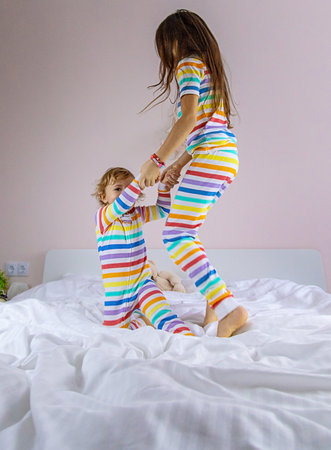 Children play jumping in bed. selective focus. kid.の写真素材