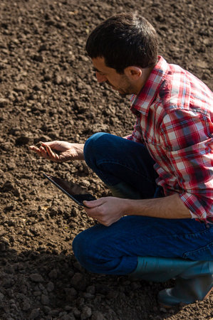 Male farmer in the field checks the soil. selective focus. Nature.