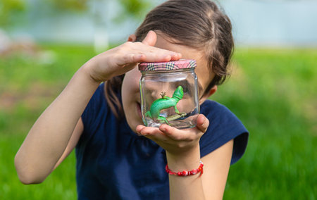Child in nature with a lizard. selective focus. kid.の写真素材