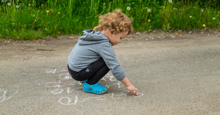 Children draw equations on the pavement with chalk. selective focus. kid.
