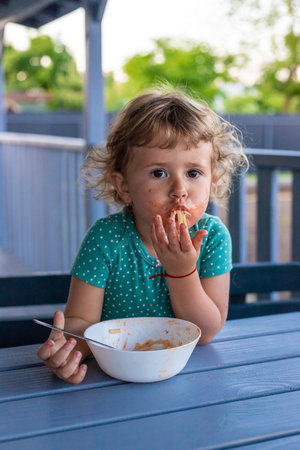 Child eats spaghetti pasta. selective focus. food.の写真素材