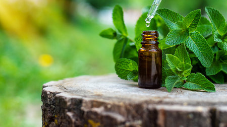 Peppermint essential oil in a bottle. selective focus. Nature.の写真素材