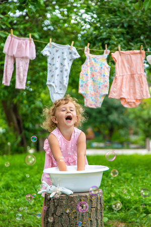 The child washes clothes and toys. selective focus. kid.の写真素材