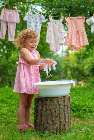 The child washes clothes and toys. selective focus. kid.の写真素材