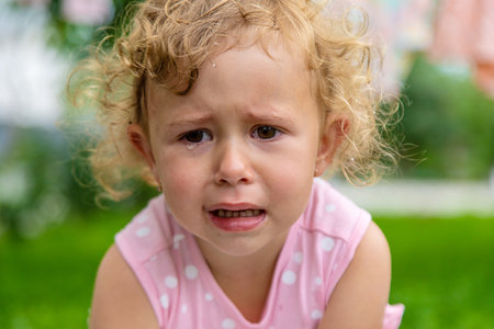 Child girl crying in the park. selective focus. kid.の写真素材