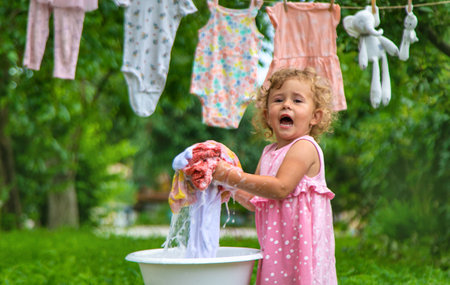 The child washes clothes and toys. selective focus. kid.の写真素材