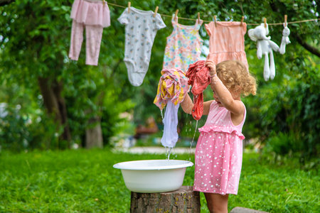 The child washes clothes and toys. selective focus. kid.の写真素材