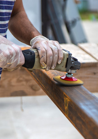 A man processes a metal pole. selective focus. nature.