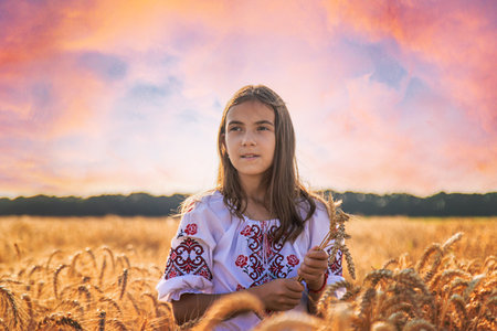 Child in a field of wheat with the flag of Ukraine. selective focus. Nature.の写真素材