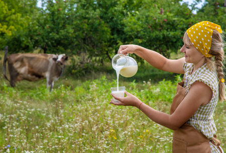 Dairy products on a cow farm are held by a woman in her hands. selective focus. food.