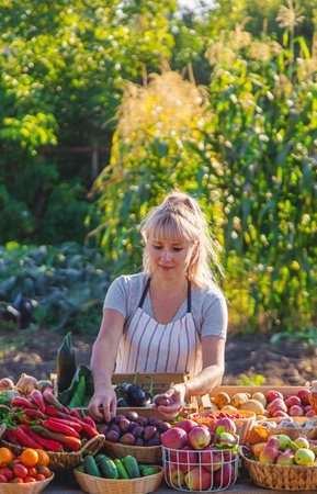 A woman farmer sells fruits and vegetables at a farmers market. Selective focus. Food.