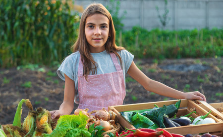 A child sells vegetables and fruits at the farmers market. Selective focus. Food.の写真素材