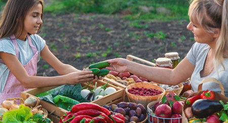 A child sells vegetables and fruits at the farmers market. Selective focus. Food.の写真素材