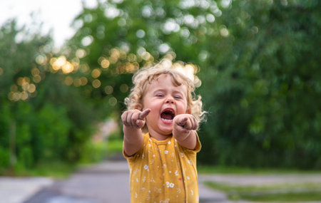 A child points his finger at a portrait on the street. Selective focus. Kid.の写真素材