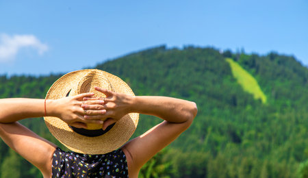 A woman in the mountains admires nature. Selective focus. Nature.の写真素材