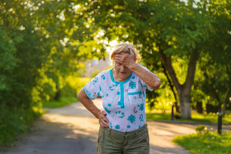 Old woman has a headache. Selective focus. Nature.の写真素材