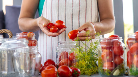 Preserving tomatoes in jars. Selective focus. Food.の写真素材
